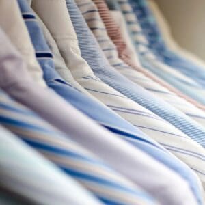 A row of ties hanging on the rack.