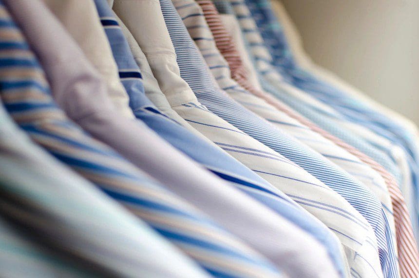 A row of ties hanging on the rack.
