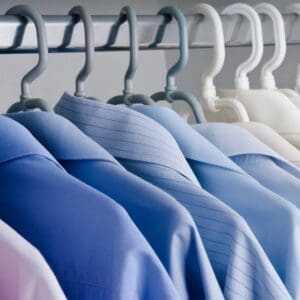 A row of shirts hanging on the rack.