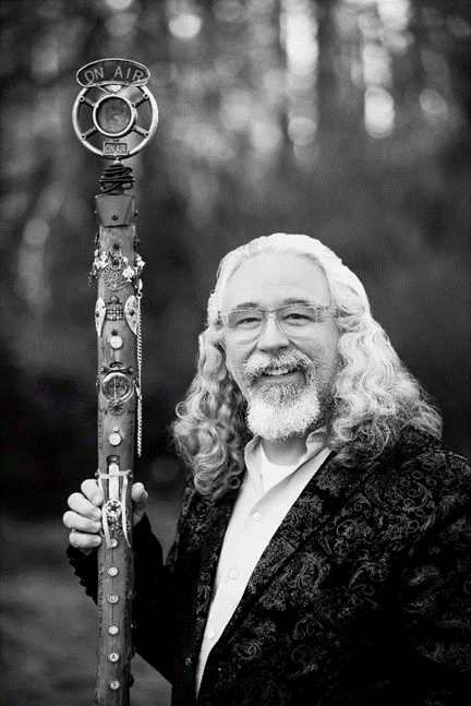 A man holding a long wooden pole in his hand.