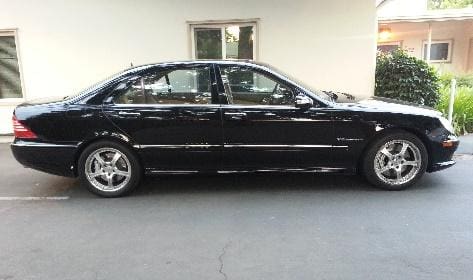 A black car parked in front of a building.